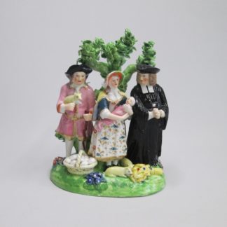 A Derby Tithe Pig Group, representing the Farmer's wife, offering her baby to the Clergyman as payment of the tithe, instead of the pig. Circa 1790