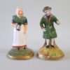 A pair of miniature Staffordshire figures of an old man and woman. Circa 1880.