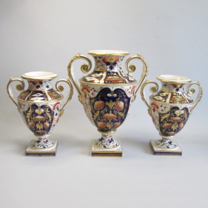 A large garniture of Bloor Derby Vases, decorated with Imari colours of iron red, blue and gold, with acanthus scroll handles and square base.  Circa 1830-35 - Image 2