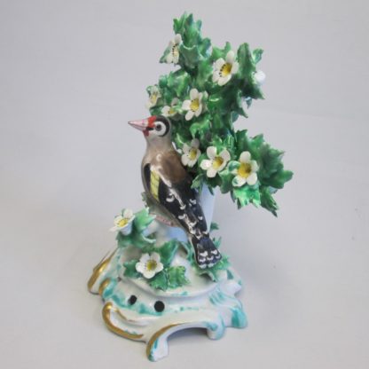 A Bow Goldfinch sat on a branch of bocage with white and yellow flowers, the base has gilded scroll work. Circa 1765. - Image 9
