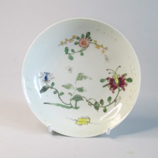 A Worcester first period Dr Wall Polychrome saucer painted in the Chinese style with the Honeysuckle or Hibiscus pattern. Circa; 1760.