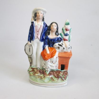 A Staffordshire figure of two children the boy "trundling" with a hoop and stick and the girl with a rabbit. Circa 1860 - Image 2