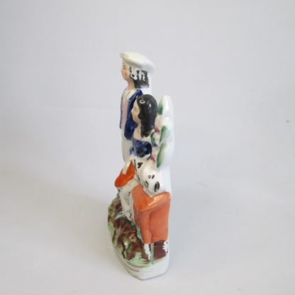 A Staffordshire figure of two children the boy "trundling" with a hoop and stick and the girl with a rabbit. Circa 1860 - Image 4