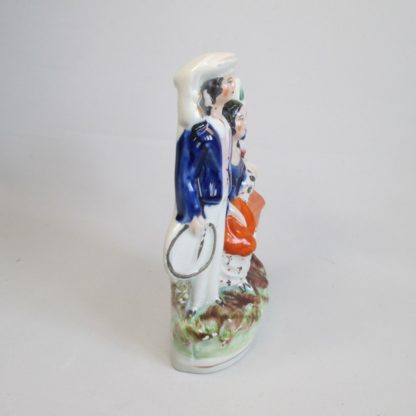 A Staffordshire figure of two children the boy "trundling" with a hoop and stick and the girl with a rabbit. Circa 1860 - Image 5