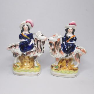 A pair of Victorian figures of the Royal children, The Princess Royal and the Prince of Wales seated on goats. Circa 1855