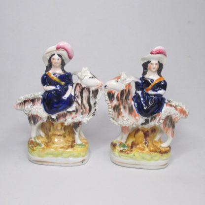 A pair of Victorian figures of the Royal children, The Princess Royal and the Prince of Wales seated on goats. Circa 1855