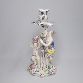 A Bow candlestick figure of Cupid and Flora the "Goddess of flowers" and the season of spring time, Circa 1758.