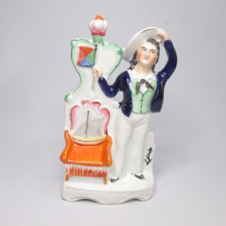 A Staffordshire pottery figure of the young Prince of Wales, standing beside a throne. Circa 1850