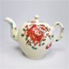 A small Creamware teapot and cover made at Cockpit Hill pottery works, Derby with hand decorated rose, leaves, cherries and other flowers. . Circa. 1765.