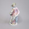 A Bow Porcelain Figure of a Lady Standing with a basket of flowers over her right arm and is representing the season of spring.  Circa 1760