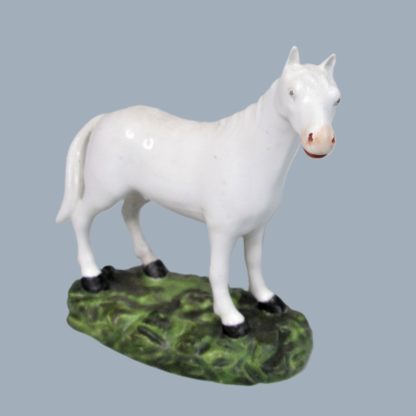 A small Derby Robert Bloor & Co porcelain model of a white Stallion. The Stallion stands on a green oval base. Circa 1810