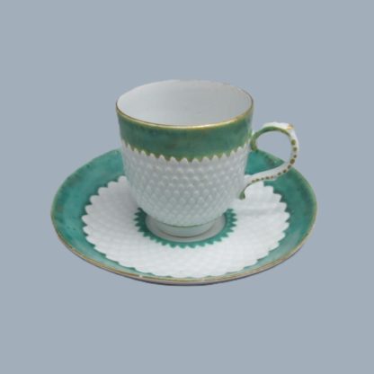 A Bow Porcelain Coffee cup and saucer with pinecone moulding and rare  anchor and dagger mark hand painted in red.   Circa: 1765-70