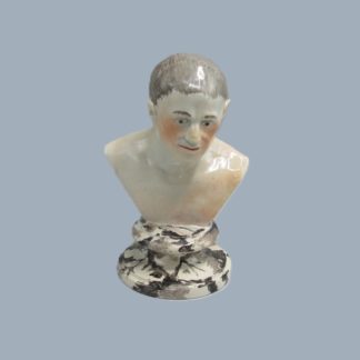 A Staffordshire small pottery bust of Seneca mounted on a marbleised soccle base. Circa; 19th Century