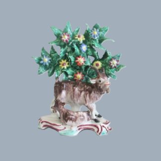 A charming Bow porcelain polychrome hand decorated model of a goat and her kid lying by her side. Circa 1758-60