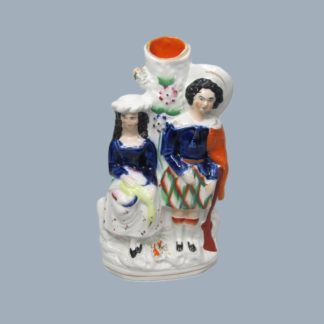 A Staffordshire spill holder group figure of a hunter and companion Circa 1860