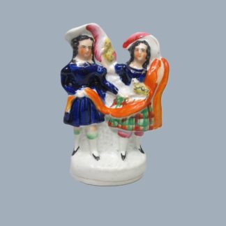 A Staffordshire Pottery figure of two children the girl with a cat and feeding a parrot, the boy holding the cats paw Circa, 1860.