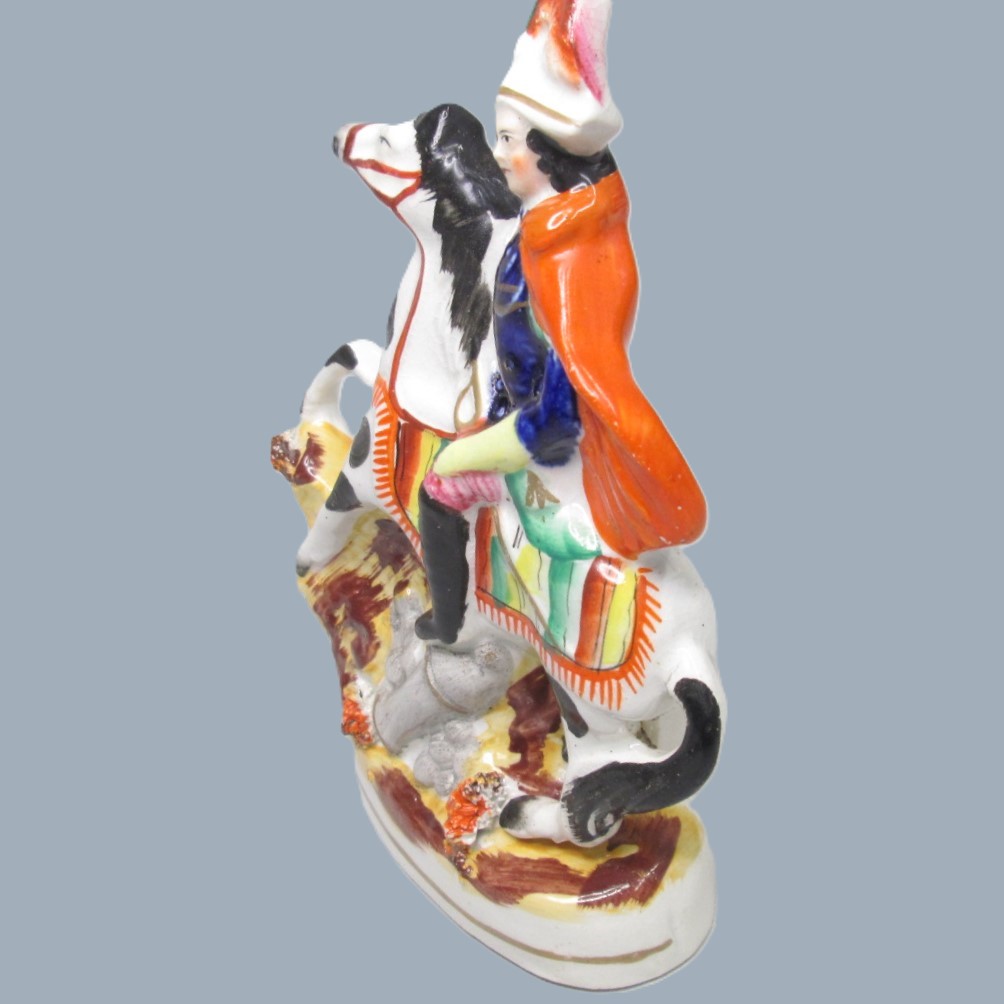 A Victorian Staffordshire military equestrian figure of a soldier with a sword and a canon and canon balls at his feet. Circa 1860. - Image 3