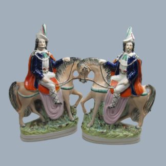 A pair of Staffordshire portrait figures of Tyrolean Brigands on horseback.  Circa; 1850.