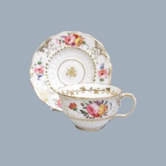 A early 19th Century teacup and saucer made by the John Rose Coalport factory, decorated by David Evans. Circa 1825-30.