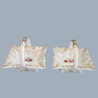 A Small Rare Pair of Bloor Derby baskets, with pierced and raised moulding, highlighted in gold, hand decorated in the centre wit rose, leaves and flowers. Circa 1830-35