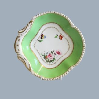 A Bloor Derby quatrefoil dish, decorated with flowers within a green band and gilding around the edges, red Crown Derby mark on the rear. Circa 1820