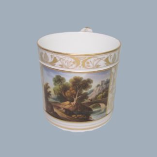 A Derby porcelain Porter mug gilded with anthemion scrolls and a colourful painted enamel panel, titled a 'view in North Wales'  Circa; 1810