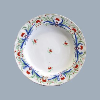A Pinxton Dish with a fluted edge, decorated in vivid coloured enamels, with the very rare puce arrow mark. Circa; 1796-1813.