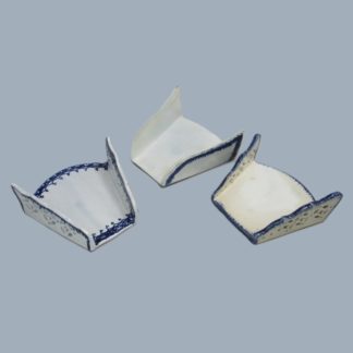 Three Staffordshire pearlware blue and white, fan shaped, asparagus servers, two with pierced sides and one plain. Circa 1790-1800.