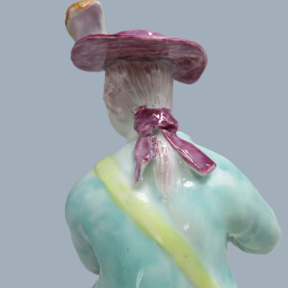 A Derby seated musician playing a flute hand decorated with a turquoise jacket and floral waistcoat and trousers. Circa 1756 - Image 5