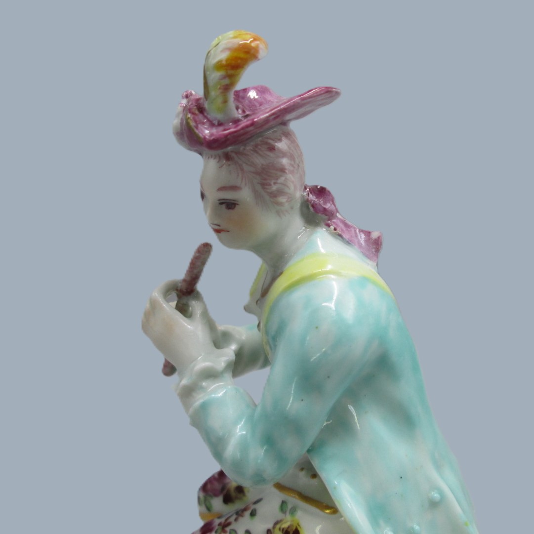 A Derby seated musician playing a flute hand decorated with a turquoise jacket and floral waistcoat and trousers. Circa 1756 - Image 3