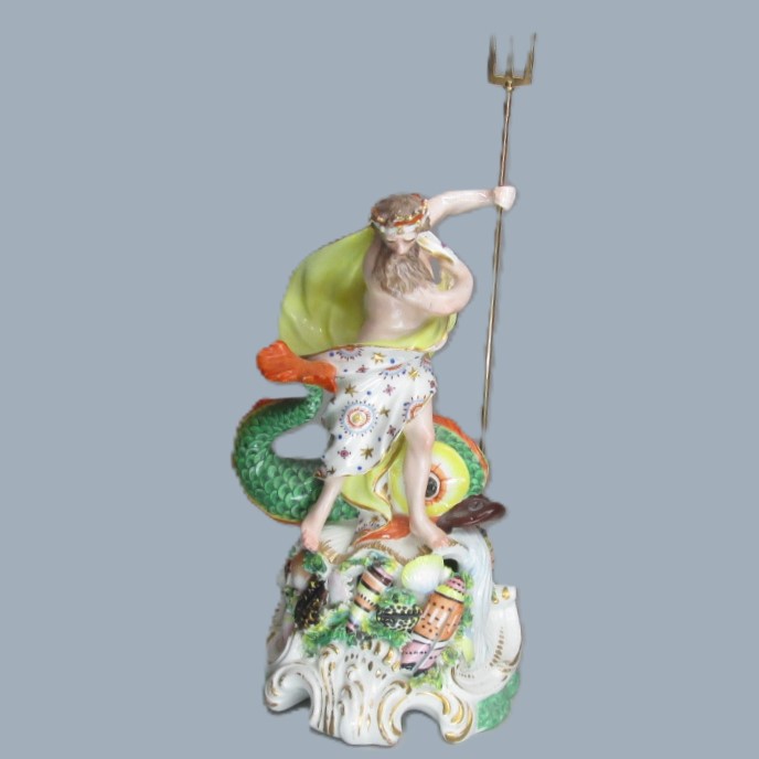 A Derby porcelain figure of Neptune, standing on a rocky mound with a large dolphin beside him and holding a trident in his left hand Circa 1760 -70
