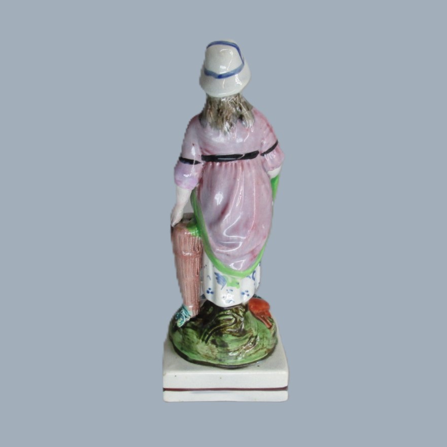 A Staffordshire pearlware square based pottery figure of a Lady holding fish in her apron, emblematic of the element 'Water'. Circa; 1800 - Image 13
