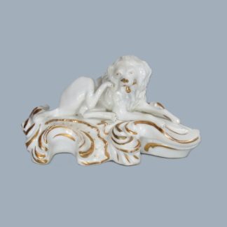 A Bloor Derby figure of a Poodle, sitting scratching his ear, on a white and gilt scroll base.  Circa 1820.