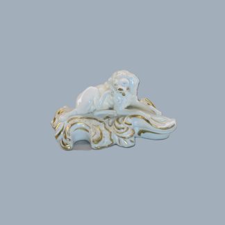 A Bloor Derby figure of a Poodle, sitting scratching his ear, on a white and gilt scroll base.  Circa 1820.